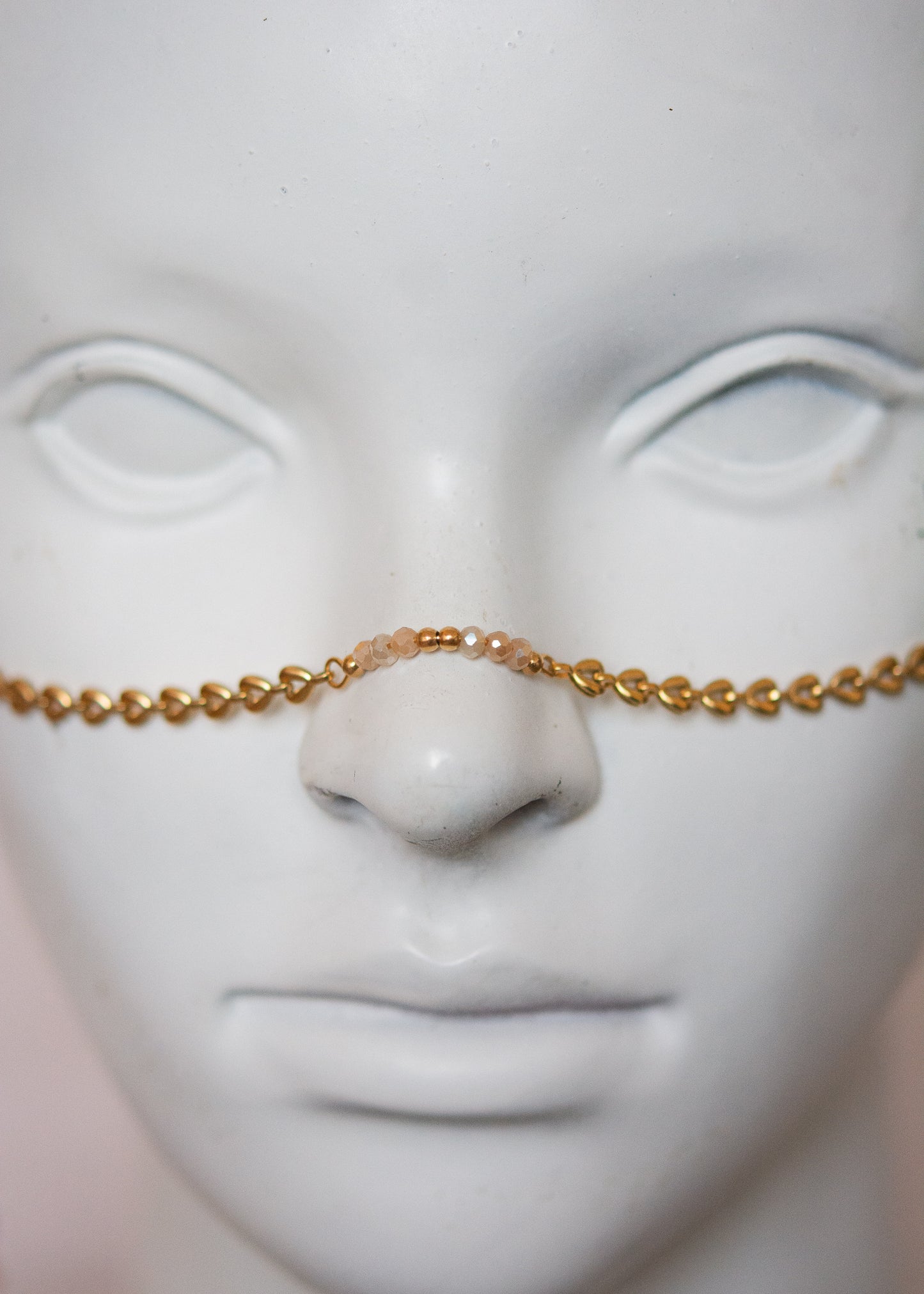 Bijou facial doré avec ambre, cristaux rosés et cornes. Accessoire festival, rituel solaire, costume tribal, photoshoot mystique.