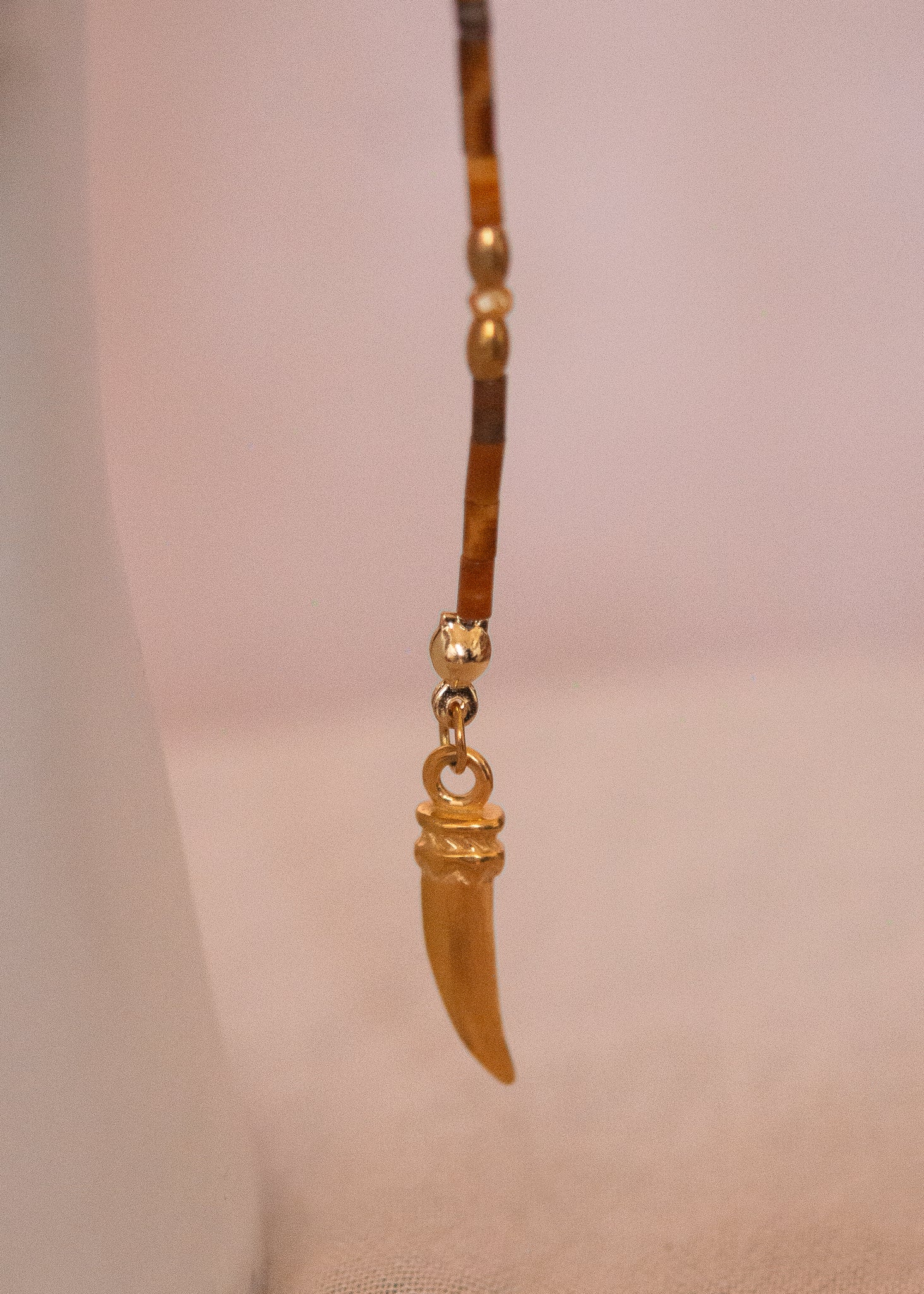 Bijou facial chamanique avec pierre œil de tigre, têtes de taureau et cornes dorées. Accessoire festival, tribal, costume ou photoshoot.