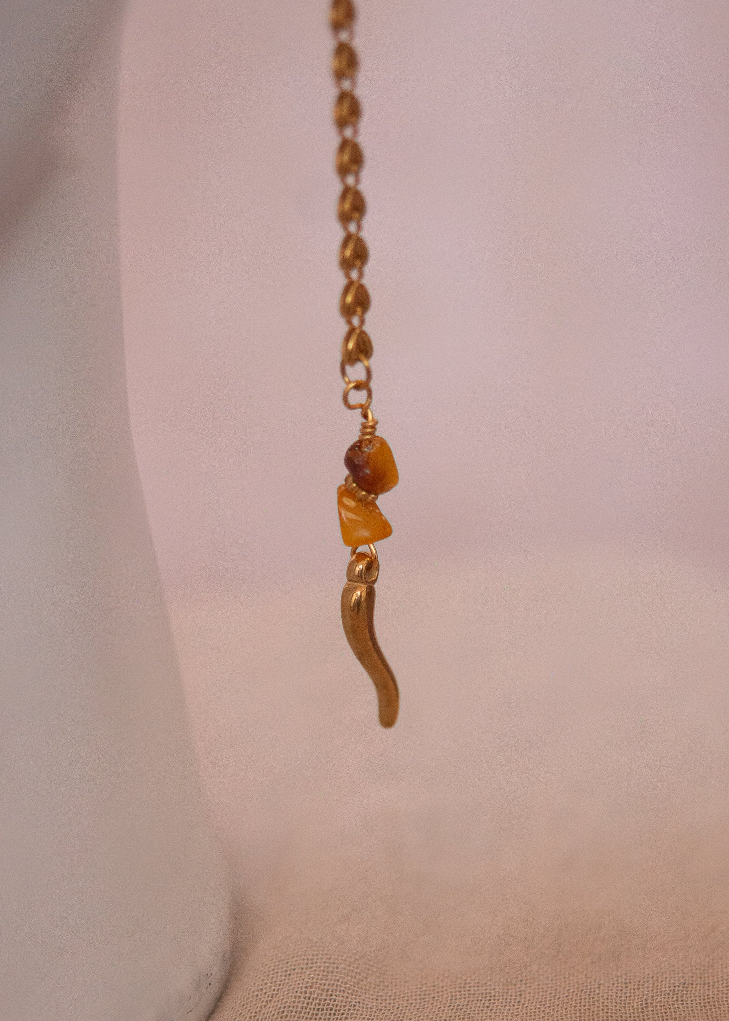 Bijou facial doré avec ambre, cristaux rosés et cornes. Accessoire festival, rituel solaire, costume tribal, photoshoot mystique.