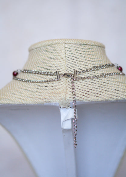 Collier en acier avec perles d'eau douce teintées rouge sang, piques, lune nacrée et charme mystique. Bijou rituel gothique, puissant et ensorcelant.