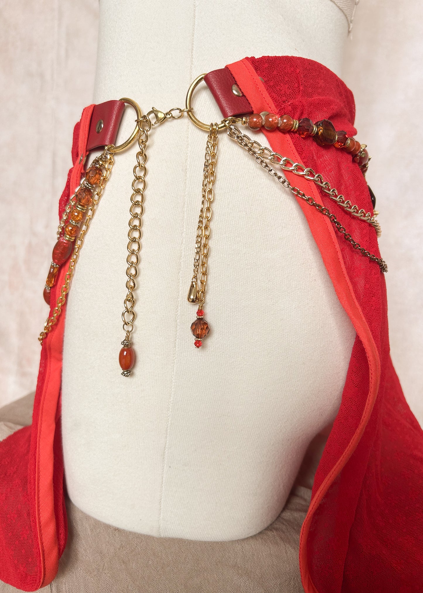 Jupe ceinture vinyle rouge, mousseline, chaînes dorées et charms. Style danse orientale, costume, festival, tribal. Fait main à Montréal.