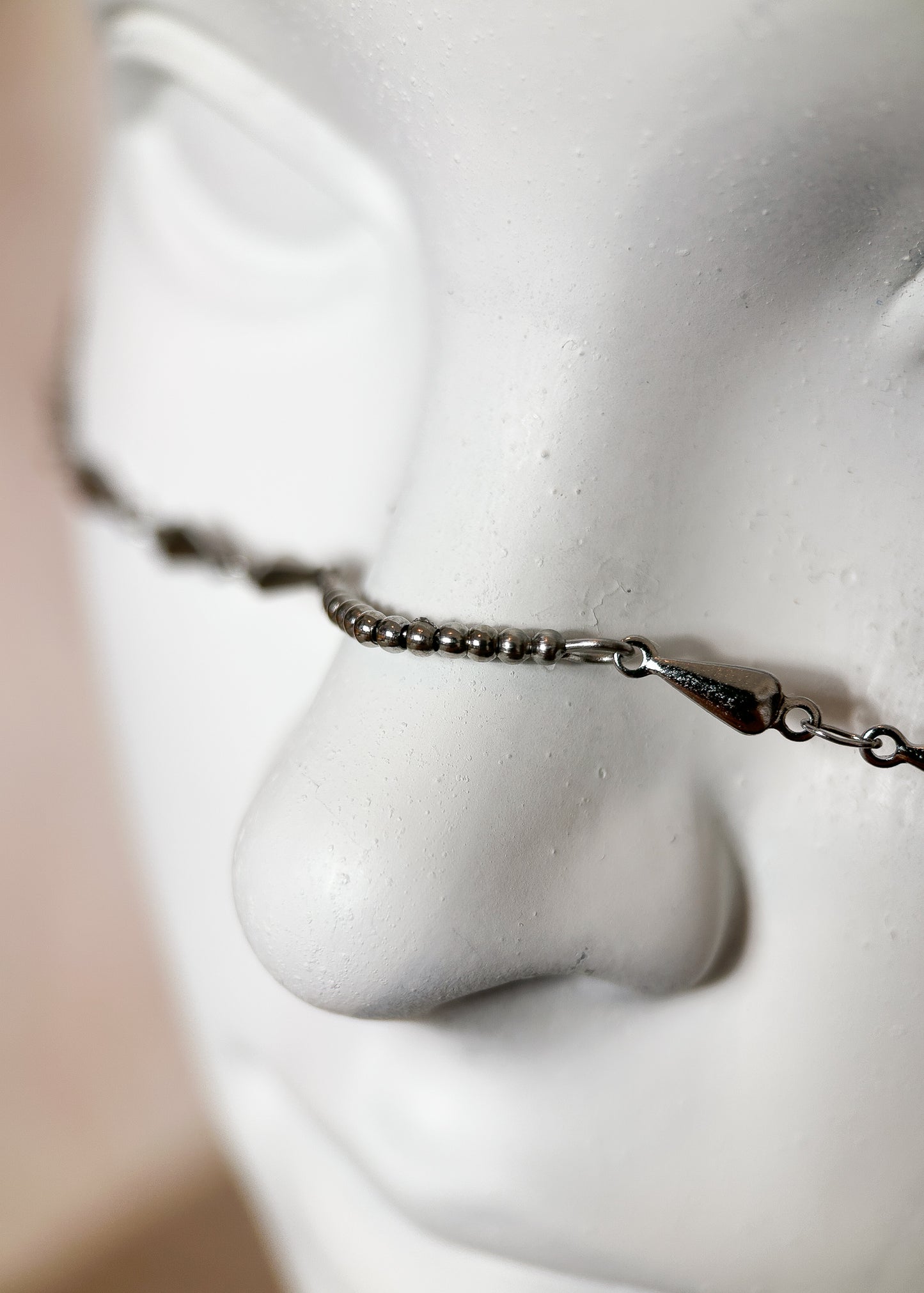 Chaîne de visage en acier inoxydable avec pendentifs serpents. Bijou facial fait main à Montréal pour festival, rave, photoshoot et esthétique mystique moderne.